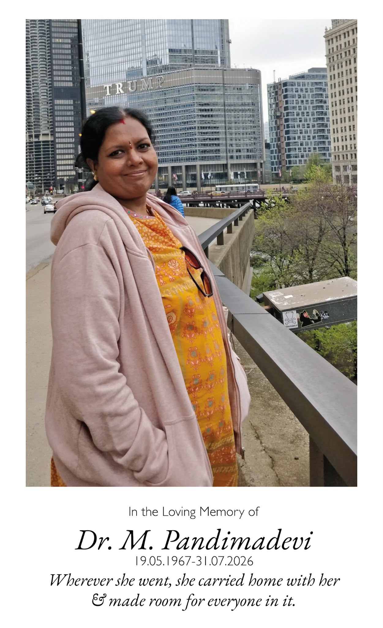 Amma standing on a bridge in Chicago. Wherever she went, she carried home with her and made room for everyone in it.